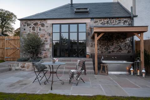 Rustic luxury at the Dairy with outdoor bath.