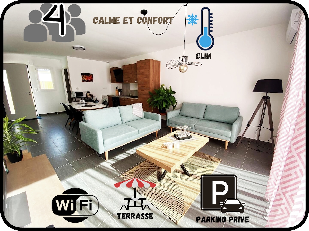 The living area is bright and inviting, furnished with two light blue sofas and a central coffee table. A dining area is visible in the background, complemented by wooden cabinetry. A wall-mounted light fixture adds a modern touch. Decorative elements are arranged throughout the space.