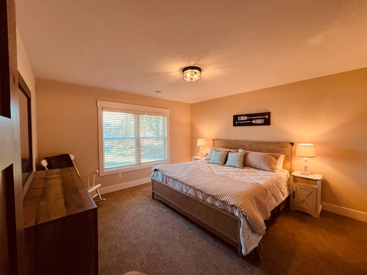 Downstairs guest bedroom with window looking out to lake.