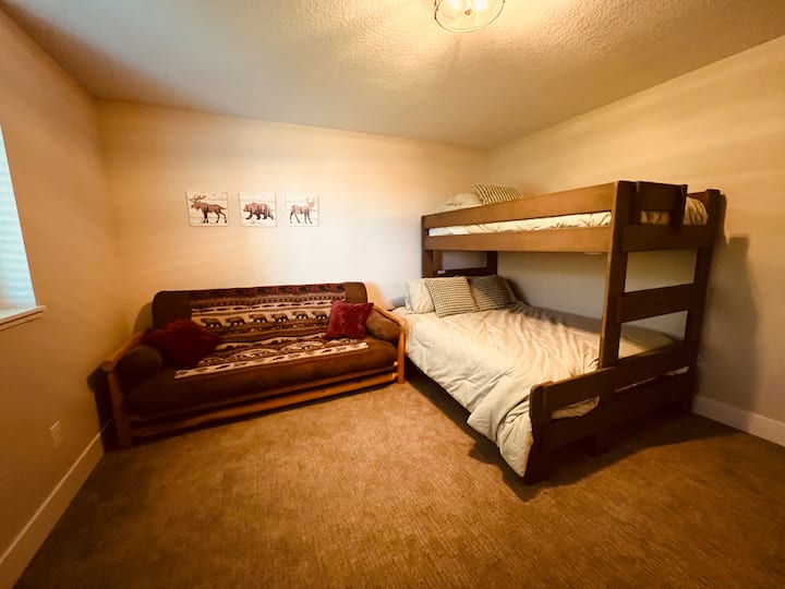 Bunk room with futon and tv.