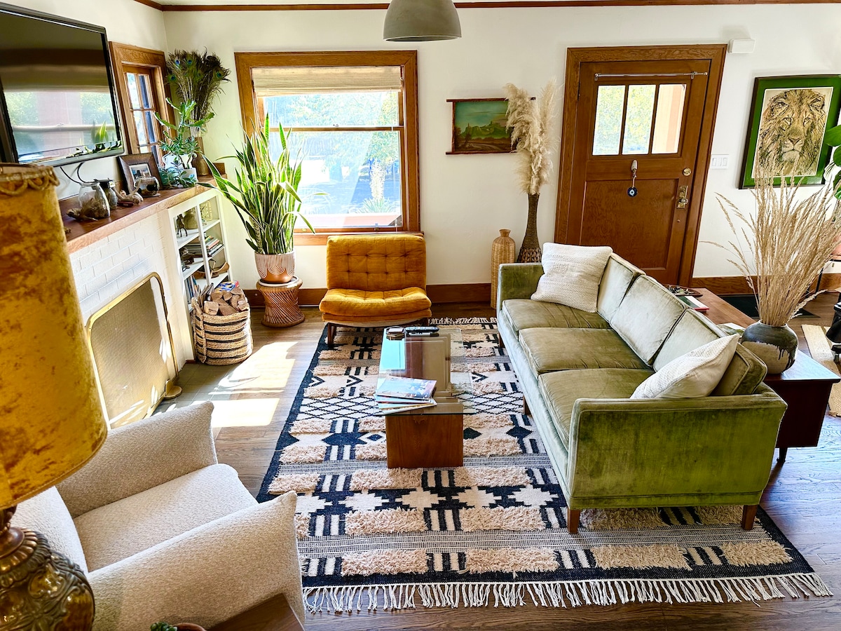 اجتمع في غرفة معيشة مليئة بالضوء مصممة للتواصل، مع أريكة مخملية عتيقة، وكراسي مريحة، وطبقات من النباتات والفن والديكور. مثالية لمشاهدة الأفلام العائلية، أو لقضاء وقت مع الأصدقاء، أو الاسترخاء معًا بعد يوم من الاستكشاف.