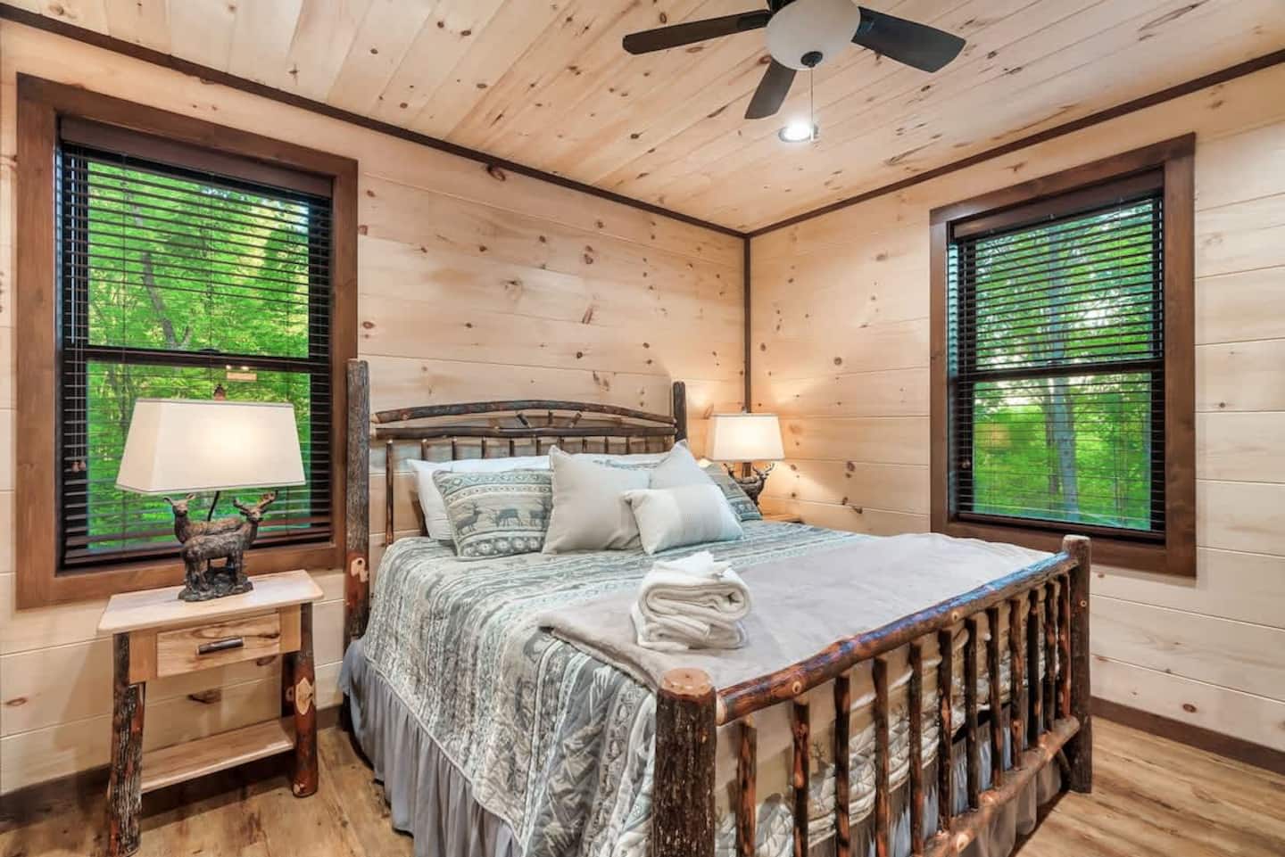 King Suite 1 — main level, pine walls, deer-motif lamp