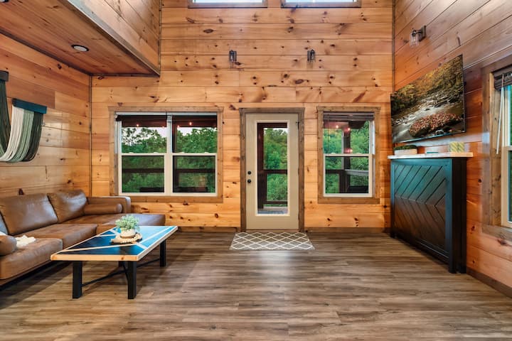 Experience the perfect blend of rustic charm and modern comfort in this bright, open living area—featuring soaring wood accents, cozy seating, and panoramic views for ultimate relaxation.