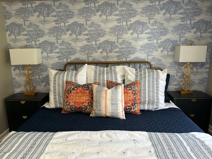 King-size bed with cooling mattress pad.  Lamps equipped with USB and USB-C ports.  Black-out curtains provide a darkened sleep environment. 