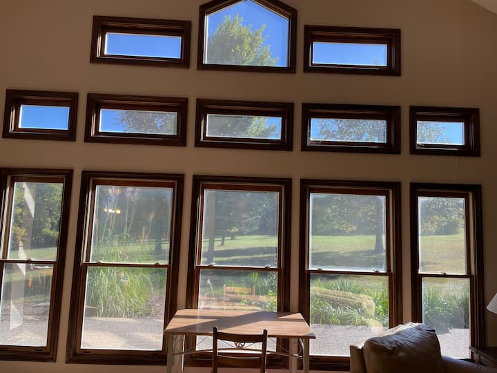 View from the living room into the front yard. Wonderful place to have a cup of coffee and slowly find your way into the morning!