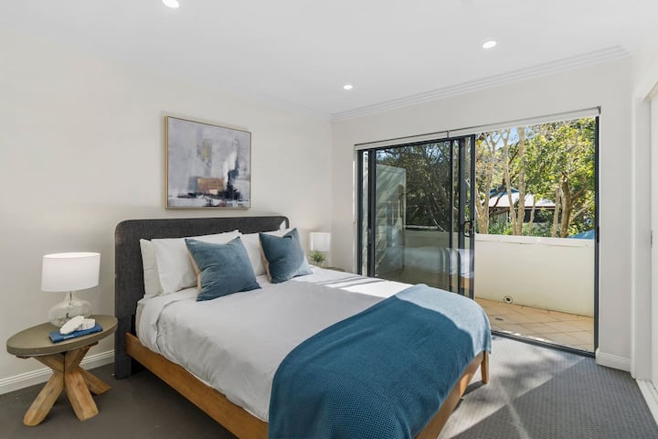 The second bedroom, located downstairs, features a plush queen-sized bed and an attached balcony—perfect for quiet moments, sipping your coffee while feeling the breeze and soaking in the surroundings.