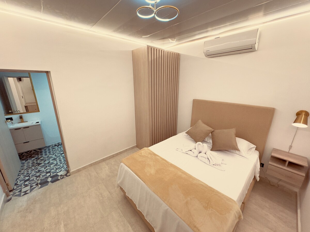 غرفة أنيقة مع حمام خاص ومكيف هواء وسرير مزدوج مثالي للراحة. 