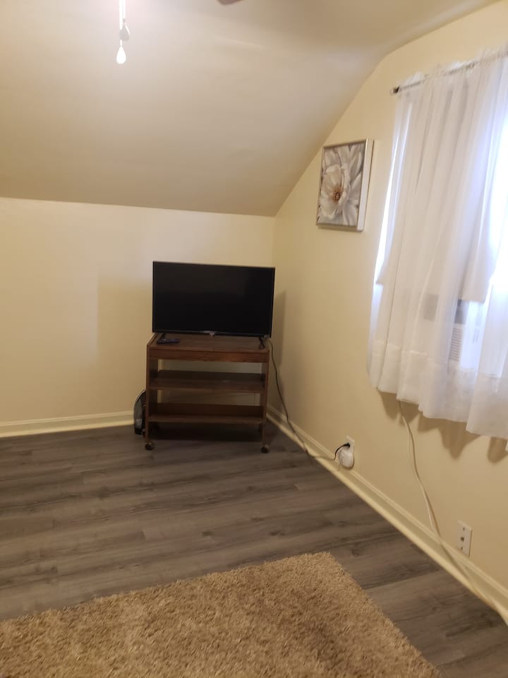 2階の寝室/オフィスには、折りたたみ式デスクとインフレータブルクイーンマットレスがあります。 