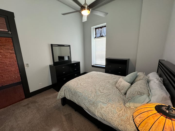 The third bedroom is in the quiet area in the back of the loft. Tall windows, upscale furnishings and a huge closet complement the space.