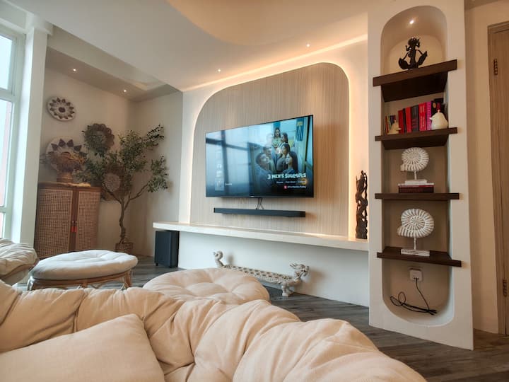 Cinema-style living room with plush seating and a relaxed evening glow.