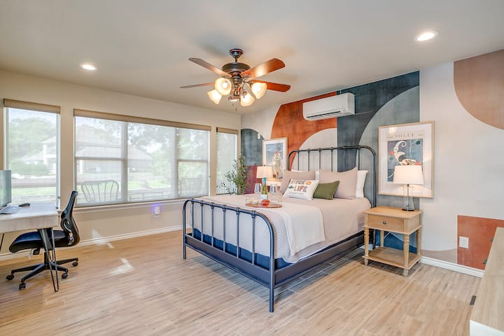 Stylish bedroom with lake-inspired art, a workstation, and modern decor.