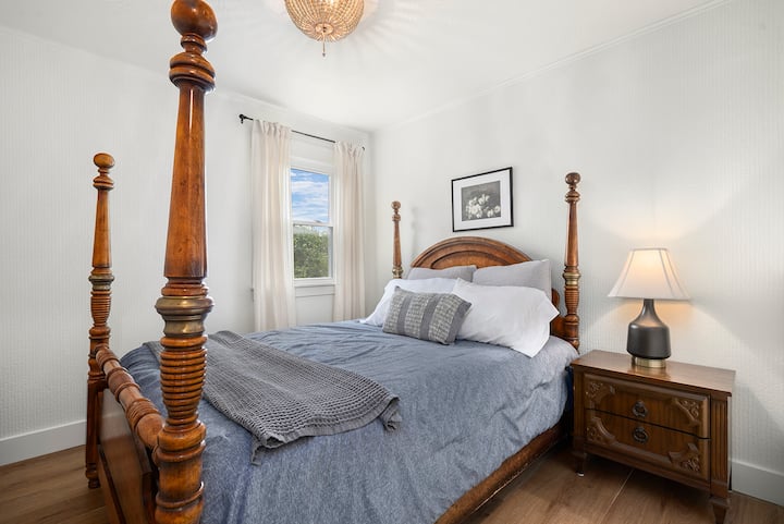 Bedroom 2 with queen bed, warm lighting, and comfortable furnishings for couples or solo guests.