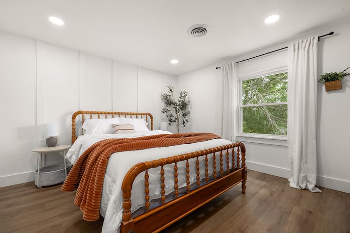 Bedroom 5 detail - nightstand, reading lamp, and stylish decor choices.