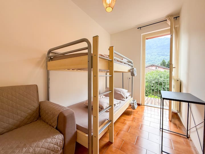 СПАЛНА СОБА СО ПРОЗОРЦИ, СО ЦВРСТ КРЕВЕТ НА КАТ И ДВОСЕД КАУЧ