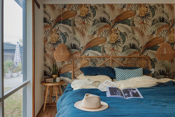 Our King bedroom, The Palms has designer wallpaper and soft flax linen bedding by Bed Threads and Sheet Society. Air conditioning and heating for comfort year-round.