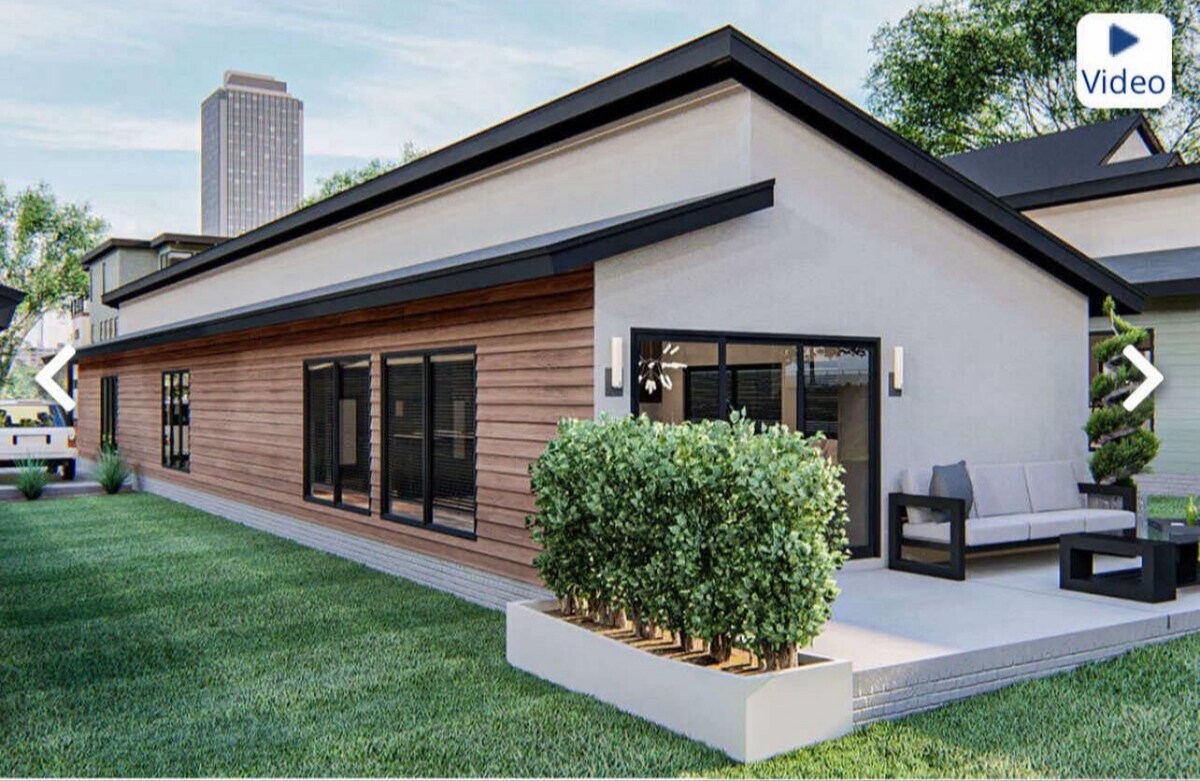 The exterior of a modern mid-century home showcases a blend of wood and stucco finishes. Large windows allow natural light to fill the interior, while a spacious patio area features comfortable seating and well-maintained landscaping, creating an inviting atmosphere for outdoor relaxation.