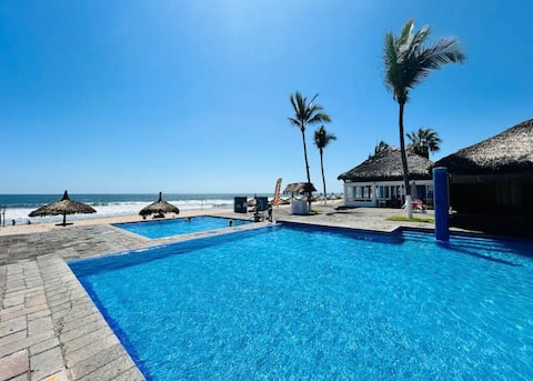 Two houses together on the beach with a private pool