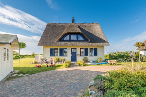 Thatch-roofed house with sea views and a sauna
