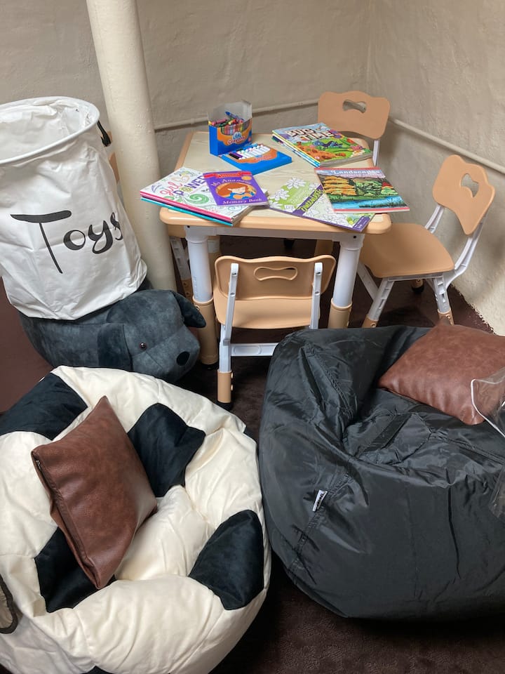 Our LOWER GROUND LEVEL consists of a Laundry Room, Second Bathroom, Family Room with Queen Sleeper Sofa, additional couch and recliner, Kids Play Nook, and your very own outdoor patio with privacy fence, firepit, grill, and outdoor furniture!