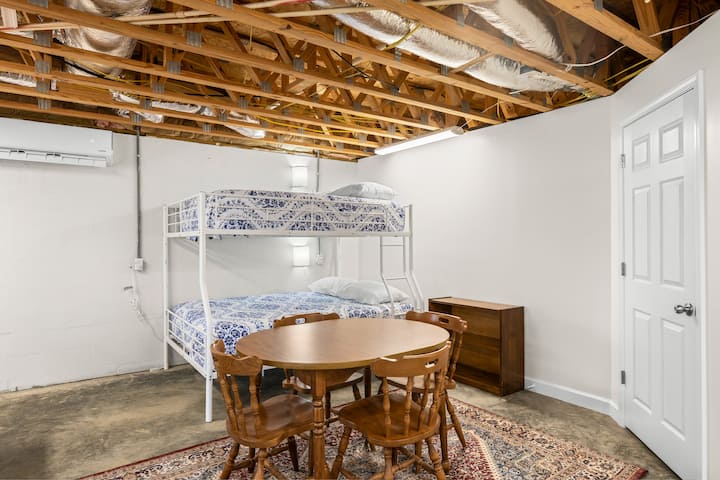 Garage is heated & cooled by its own separate mini split HVAC unit, operated by remote control. The bunk bed is a full mattress over a queen. The garage has a bathroom, right in the stairwell. 1-2 people could also sleep on the leather couch.  