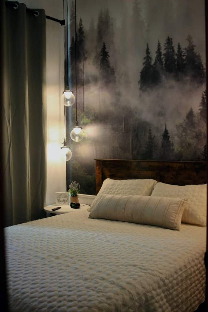 Bedroom 1 — Master Queen with woodland mural