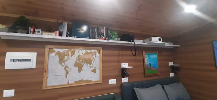 Games, books, binoculars, projector, scratch map to document guests home country, custom art painted by famous local artist 