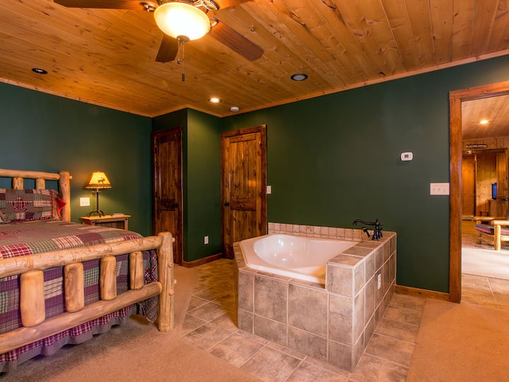 Knotty Pine Suite (View One) has a king bed, large in-room soaker tub and shares a bathroom with full shower with the bunk room.