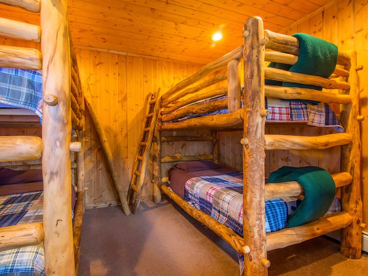 The Bunk Room has four bunk beds and shares a full bathroom with walk-in shower with Bedroom 1 (Knotty Pine Suite). 