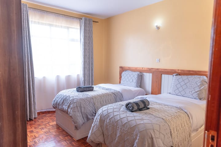 Guest bedroom with two twin beds sleeps two. Bed can be combined to make a 6x6 (King) bed