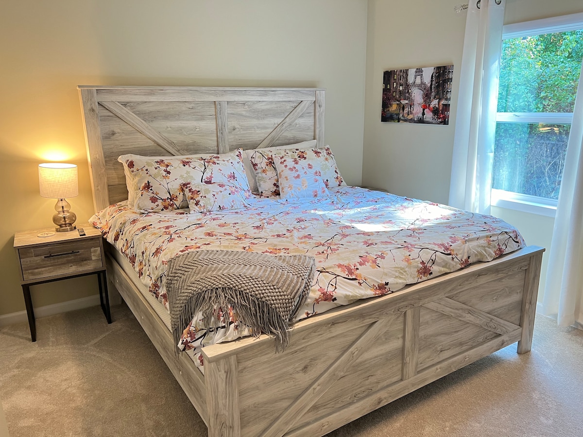 Голямо двойно легло с двойни нощни шкафчета, скрин, голям килер и 55 - инчов телевизор.