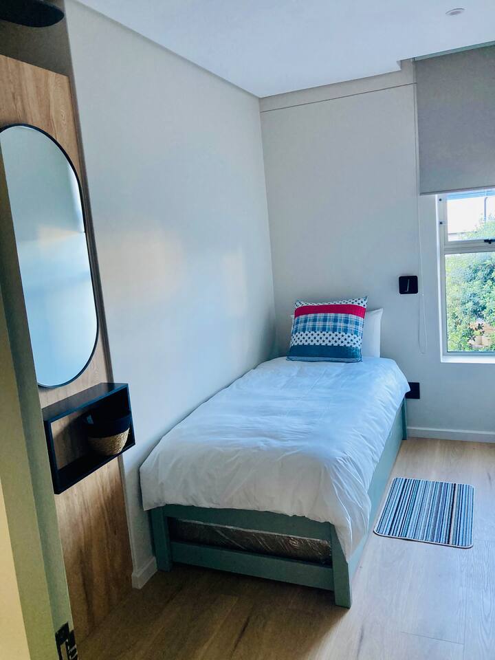 The kids' bedroom sleeps up to four, with two single beds and two pull-away mattresses — perfect for little ones sharing the adventure.