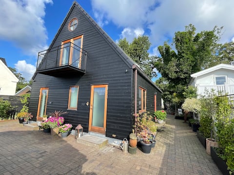 Beautiful wooden house by forest and beach