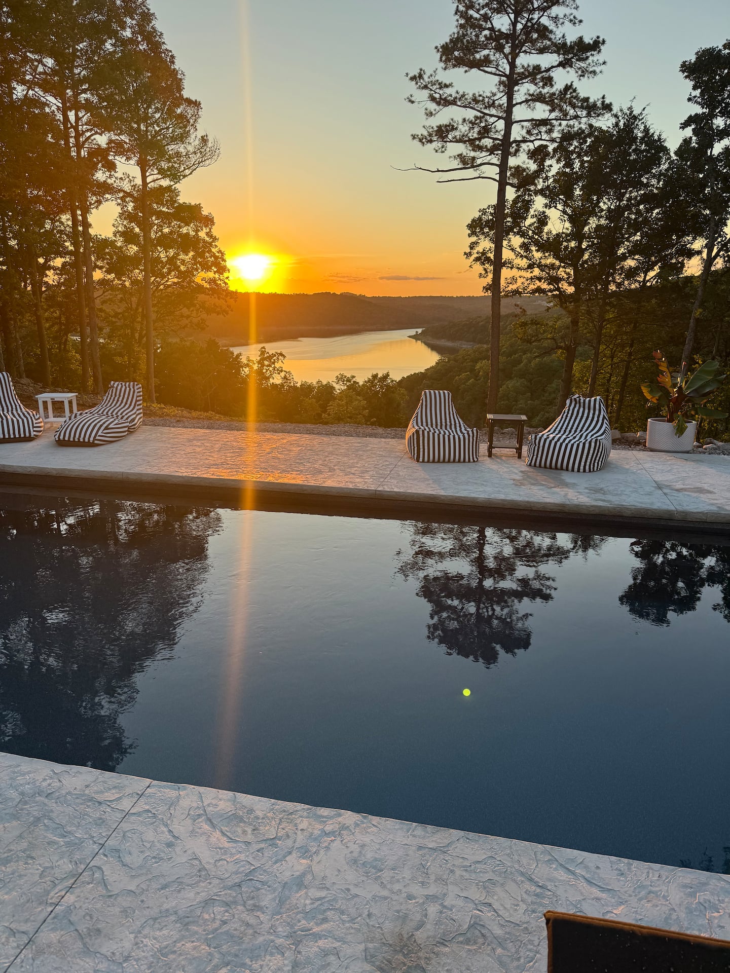 Resort style pool at sunset overlooking Norfork Lake