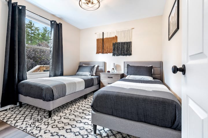 Bedroom Retreat: Charming twin beds, stylish decor, and two twin XL beds ; overlooks pool area