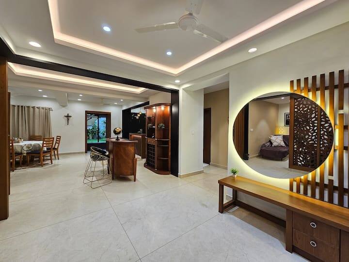 This is the First thing you see when you enter , it's the foyer area with a large aesthetically placed mirror with the Large bar area
