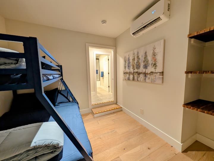 Small first floor bedroom. There is one step down to enter. The door leads to the front porch where you can sit and sip coffee. Twin over full bunk