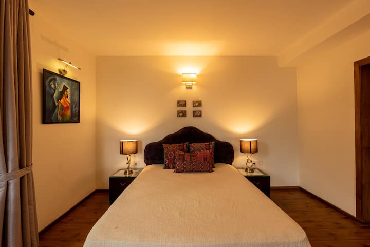 In this bedroom, you'll find a cozy bed, soft lighting, and all the little touches to make you feel right at home.