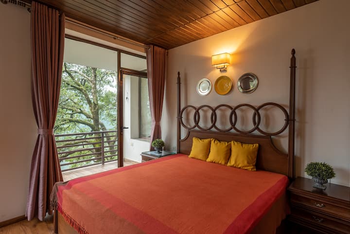 Bedroom offers a tranquil retreat with a plush bed dressed in crisp linens and soft lighting. Neutral tones create a calm ambiance, while large windows invite natural light and scenic views, making it the perfect cozy escape for restful nights.