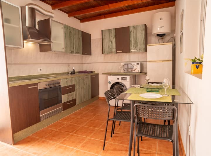 Cocina completa con lavadora, horno, microondas y mesa: todo lo necesario para tu estancia.