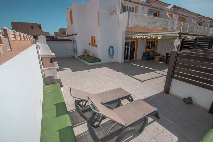 Patio exterior con tumbonas y bancos: mucho espacio para tomar el sol en privado.
