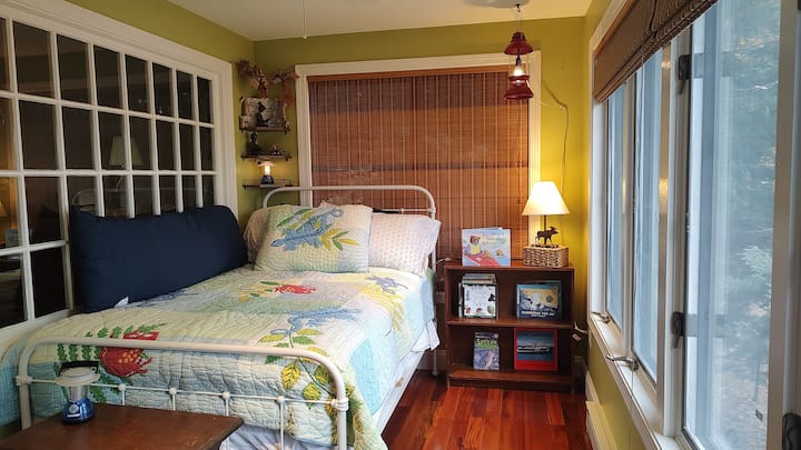 Bedroom #2. Main level. The bed is an antique 3/4, meaning that the mattress measures 48" x 75". 

The room is 7' x 11'. It has the feel of sleeping on a porch, but it is fully insulated and part of the original house. 

There is not a TV in the room