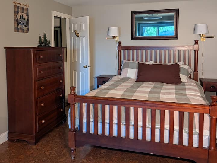 Bedroom #3. Downstairs in daylight basement. Direct access sliders to the patio and view of the lake. 1 Queen bed (60"x80"). 2 dressers, 2 nightstands, 1 closet. Bedroom is 10' x 15', with an additional 7'x12' reading nook.