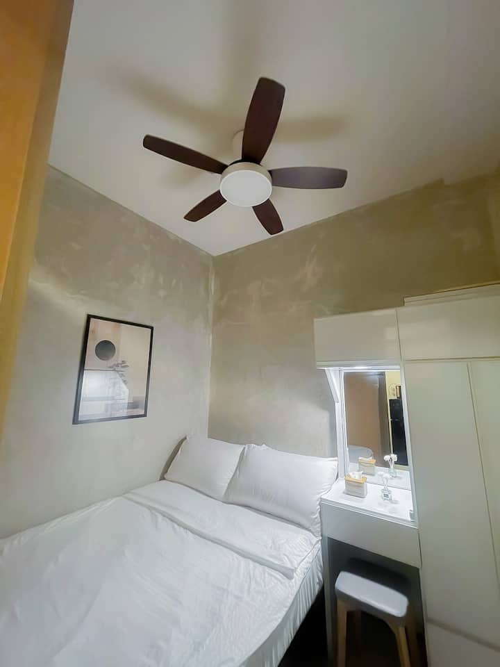 Ceiling light and fan, and a queen size bed.