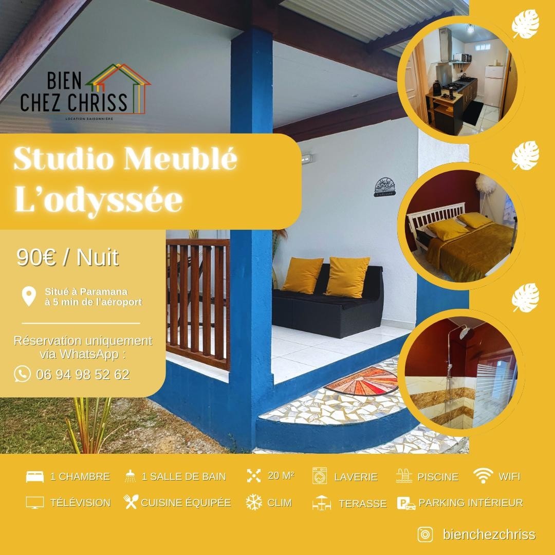 A cozy studio is presented, featuring a comfortable bed and a small dining area. Natural light enters through large windows, illuminating the space. Decorative elements add character, while a private outdoor area with a jacuzzi awaits relaxation.