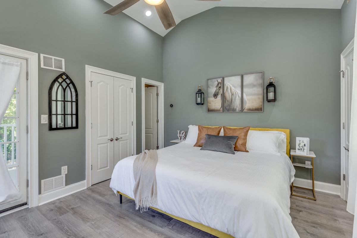 Fearless:  Primary Bedroom with En Suite Bathroom + King Bed + Three Makeup Stations + Private Balcony Overlooking the Back Yard + Two Closets + Photo Op Wall