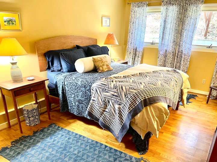 The master bedroom features a Queen with an organic latex mattress, a custom headboard made of local cherry, a closet, dresser, and book shelf. Its private master bath has a separate shower and bathtub. 