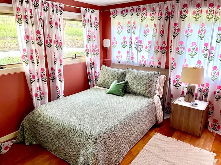The second bedroom has a comfortable double bed and gorgeous textiles— it’s by the hall bathroom and has a desk and chair, and closet. 