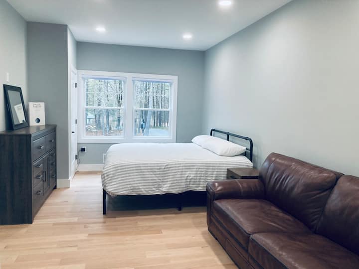 First floor bedroom with king size bed, couch coffee table and en suite bathroom.