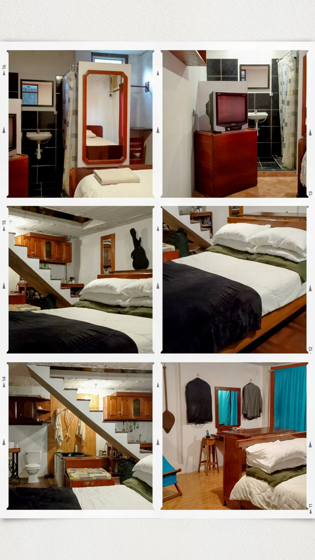 A cozy bedroom features a spacious bed dressed in soft linens, with dark blankets folded neatly. A curtain-draped window allows natural light to enter gently. A wooden dresser and a full-length mirror are included, along with wooden storage cabinets visible in the adjoining area.