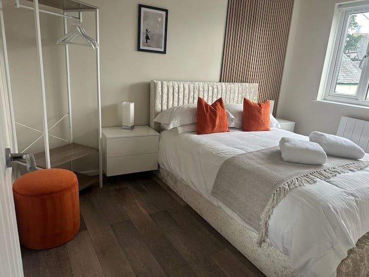 King size bed, large smart wall mounted TV,  touch sensitive lights with usb charging ports.